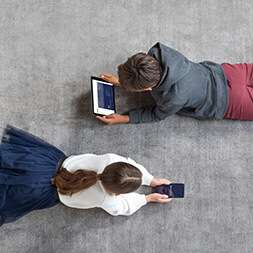 two kids gaming on rug