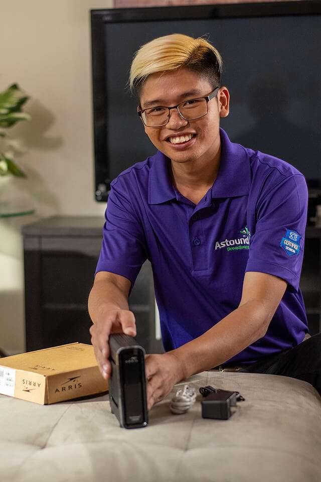 astound employee setting up a wifi dock