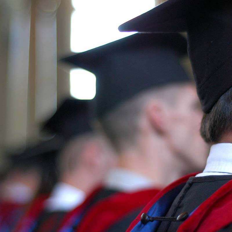 young men standing in a line at graduation