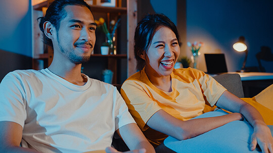 happy couple watching tv
